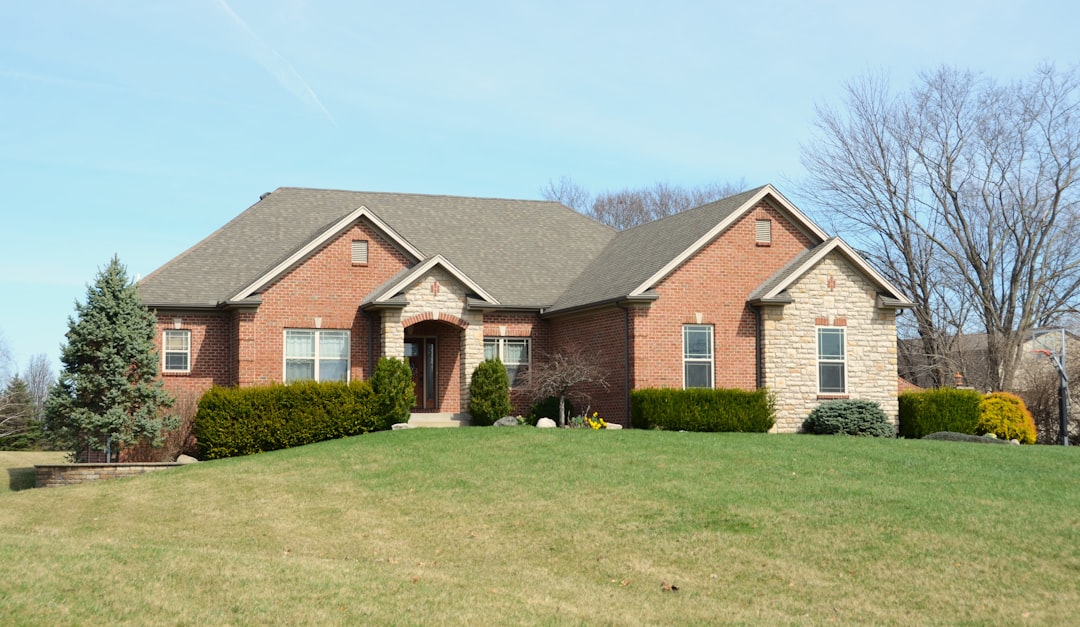 Newly installed landscape with paver walkway, planted beds, and fresh sod at a Jackson Tennessee home
